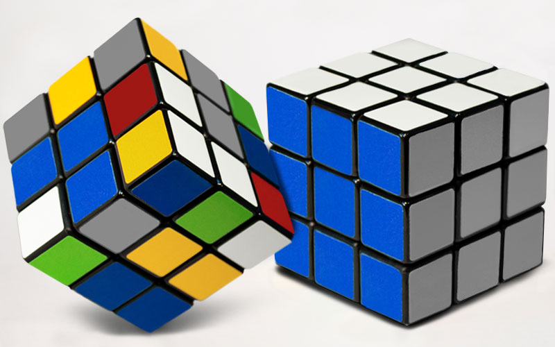 Two Rubik cubes in different colours
