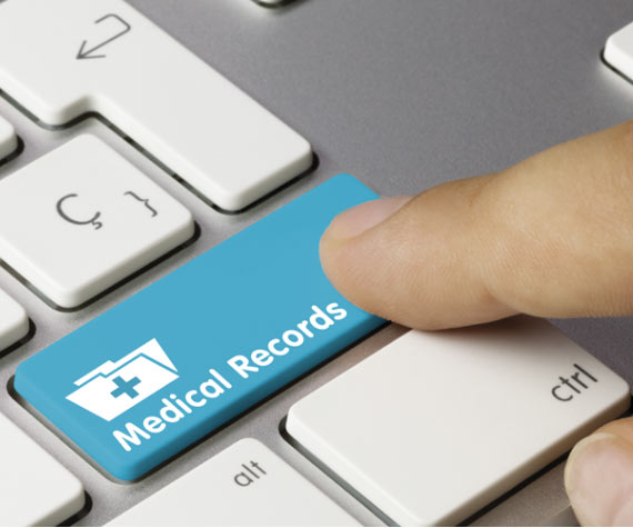 Man pressing a blue keyboard key called Medical records